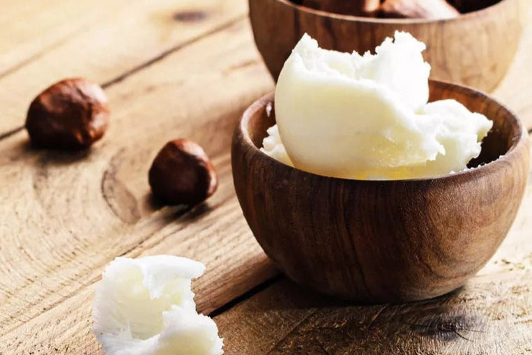 Wooden bowl with white cream-like substance on a wooden surface