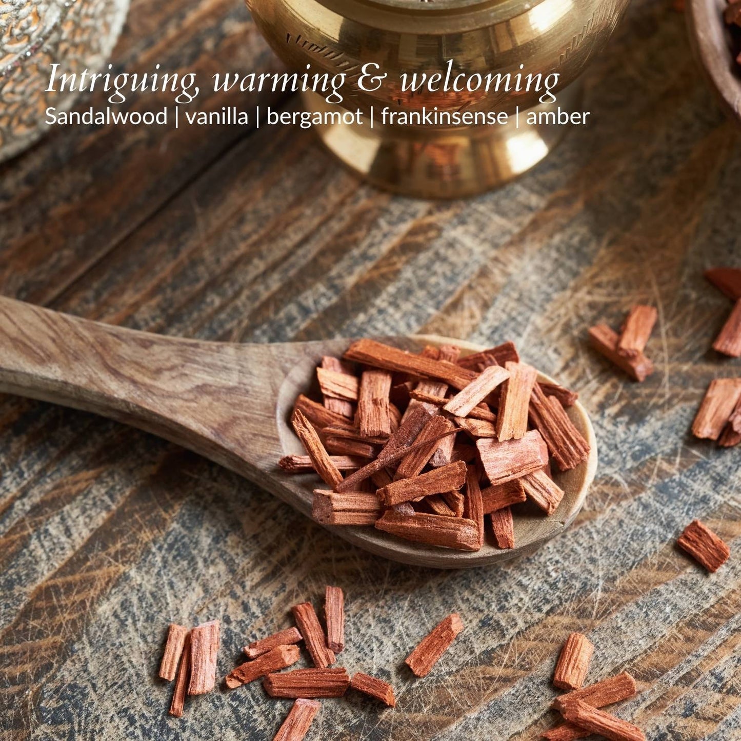 close up of sandalwood pieces intriging warming and welcoming soy candle with sandalwood vanilla bergamot frankinsense amber by dear heart nz