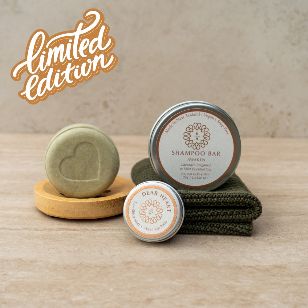 gift box containing awaken shampoo bar lavender mint bergamot and patchouli with an organic cotton washcloth and mint lip balm in a tin