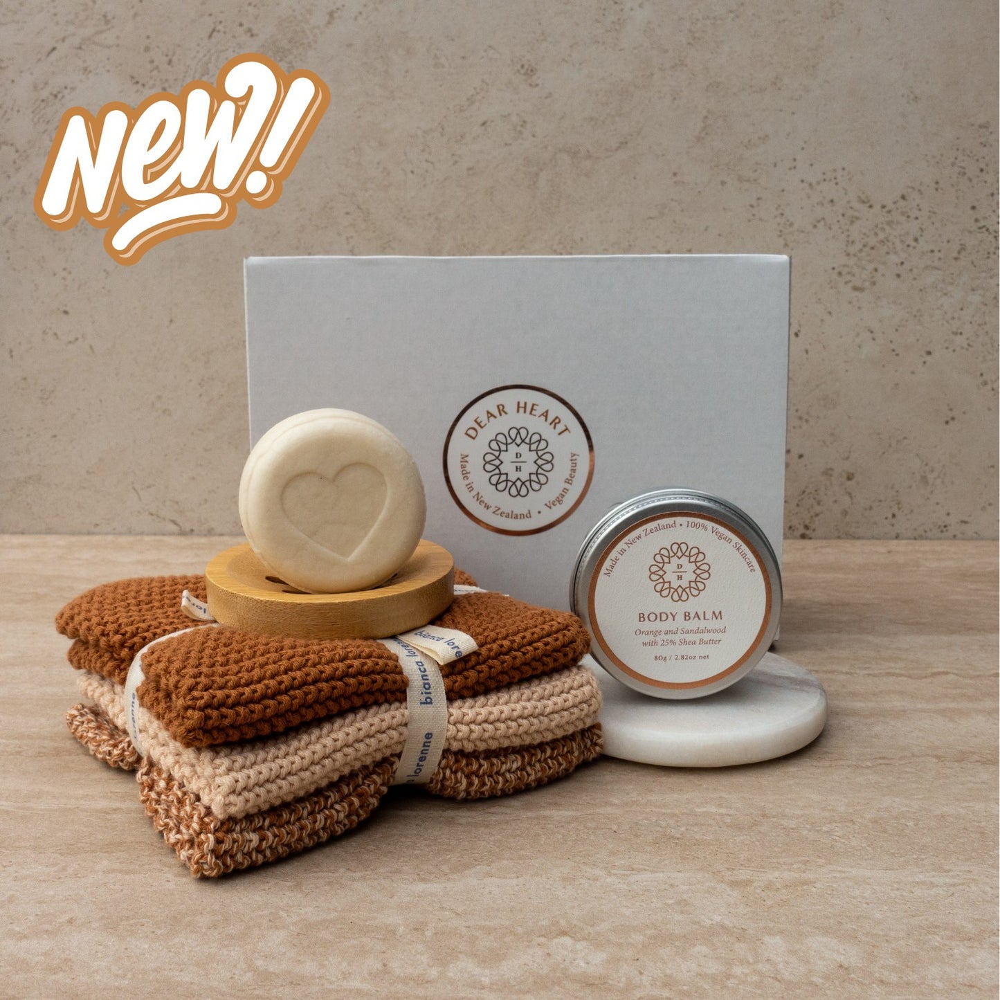 perfect gift box for her containing 80g face and body wash bar for sensitive skins, vanilla flavour with soothing colloidal oatmeal. Also a body balm 80g in an aluminum tub. Washcloth trio knitted style in a warming colour.