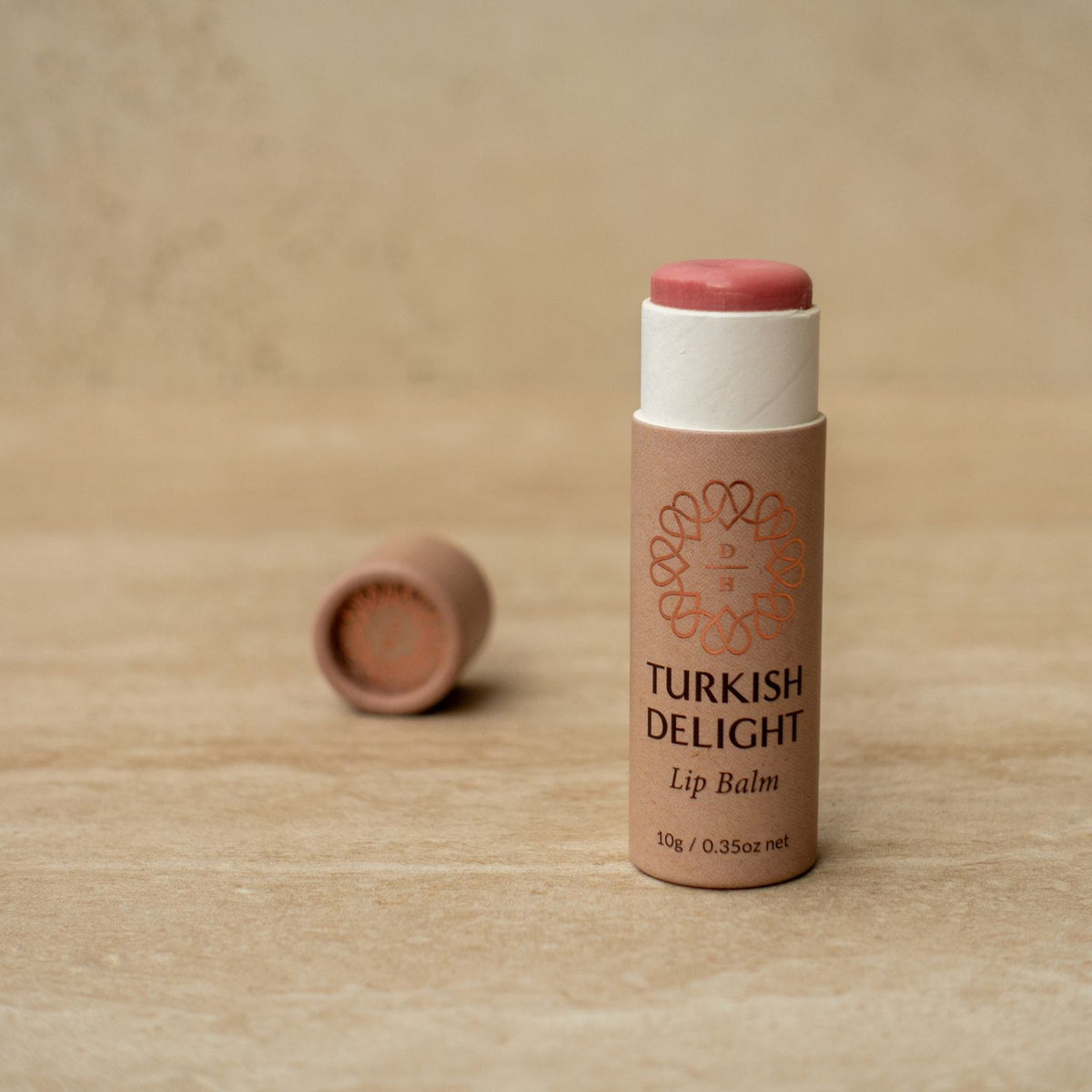 lip balms made with natural ingredients turkish delight type with rose geranium essential oil slightly tinted pink with shimmer in a cardboard tube made in nz