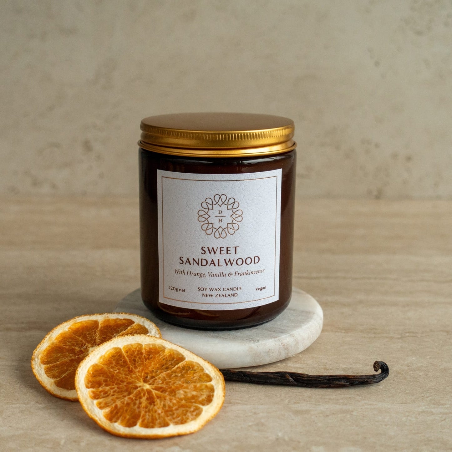 Sweet sandalwood soy candle in a glass jar with orange vanilla and frankincense oils made in nz