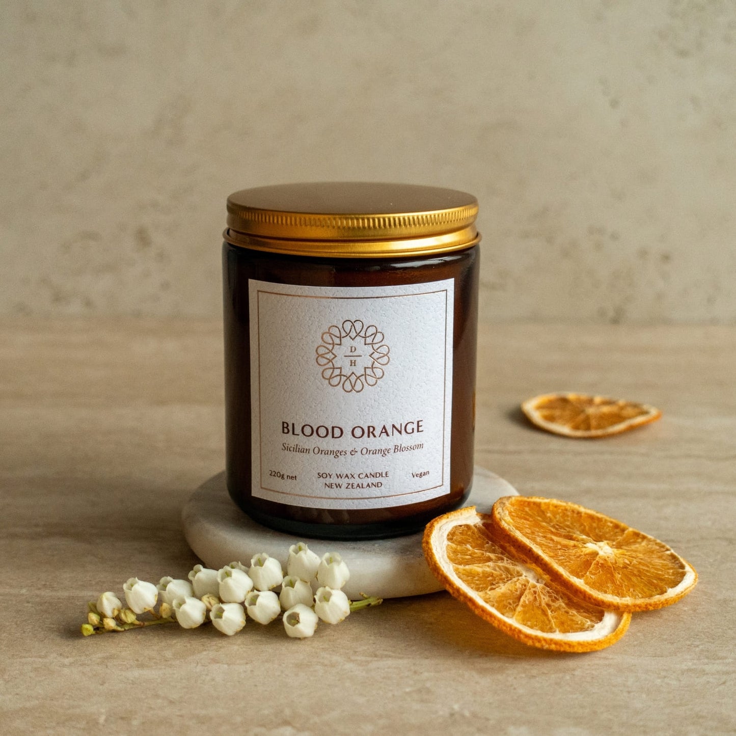 orange fragranced soy candle in amber glass jar with gold lid made in nz