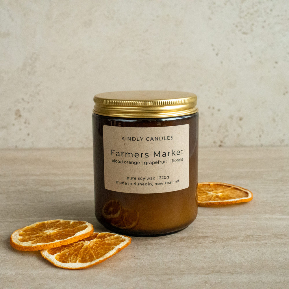 Soy wax candle hand poured and made in nz fragrance Farmers Market with blood orange grapefruit and floral in an amber jar with gold aluminum lid